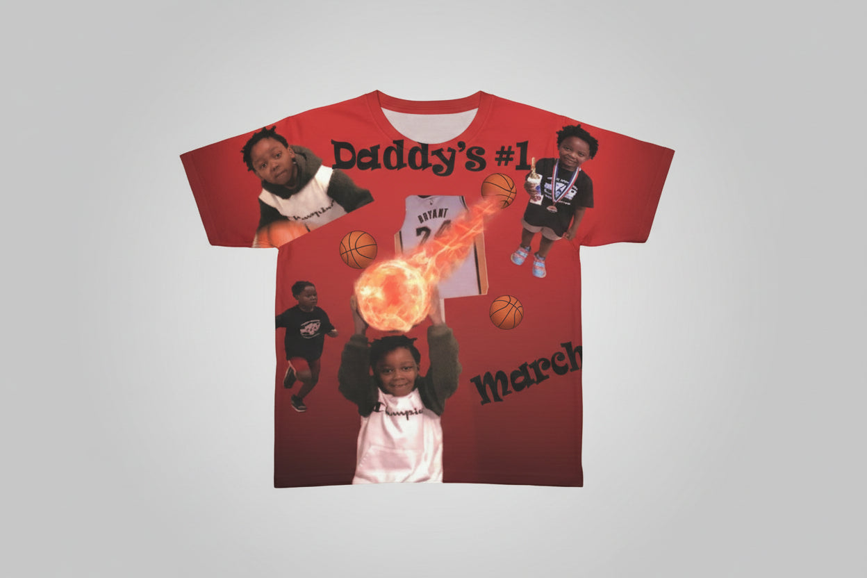 Red t shirt with images of a person and text, placed on a surface with books and objects in the background.